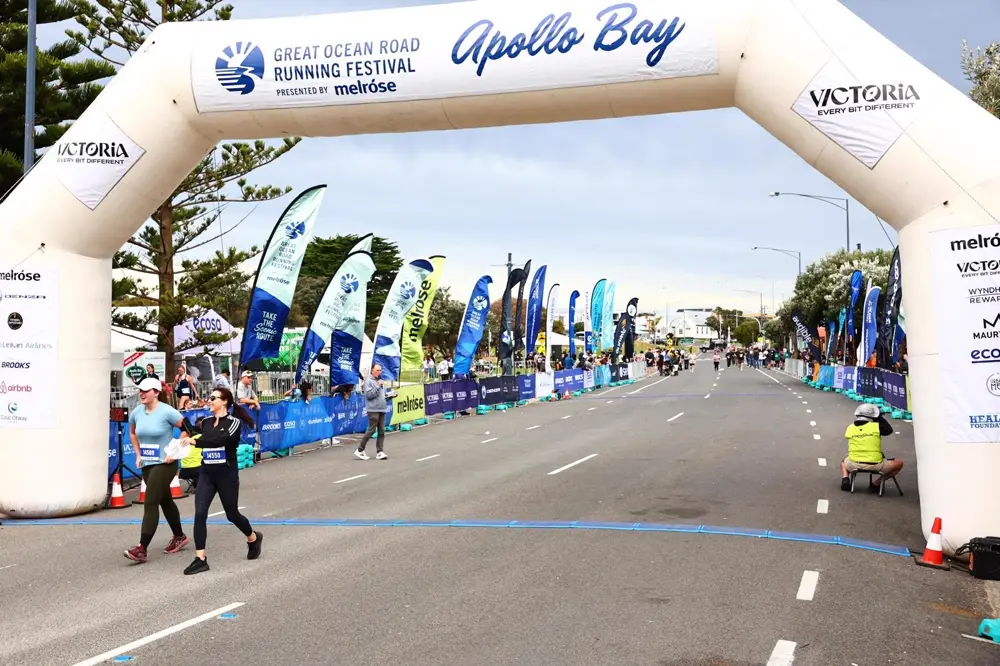 Runners crossing the Great Ocean Road finish line
