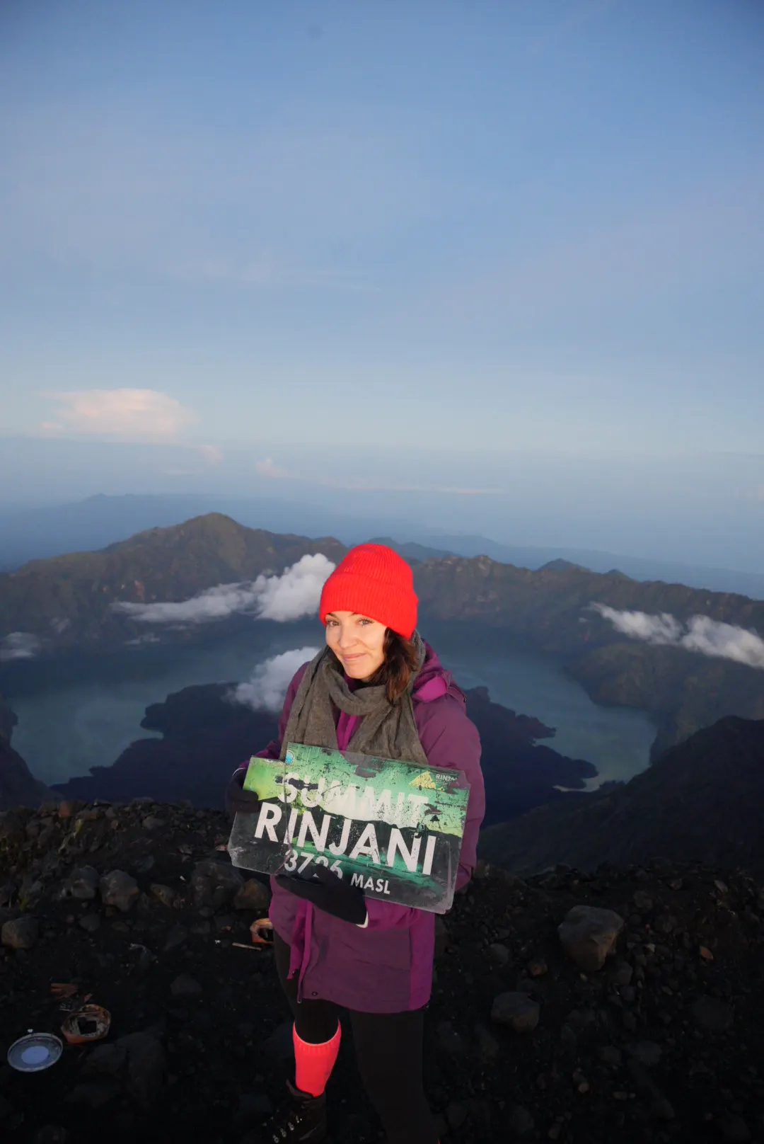 Woman at the mountain summit in the early morning light