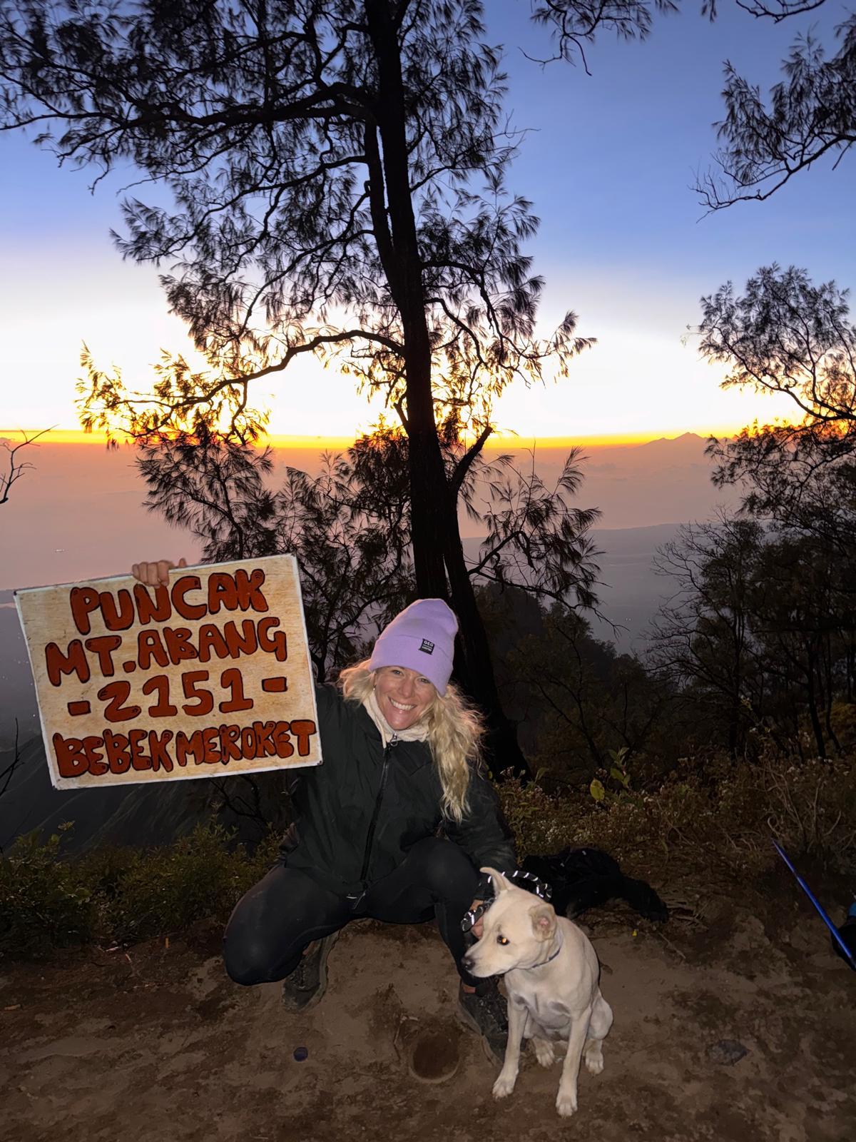 Lizzie at the summit of Mt Abang at sunrise with her rescue dog