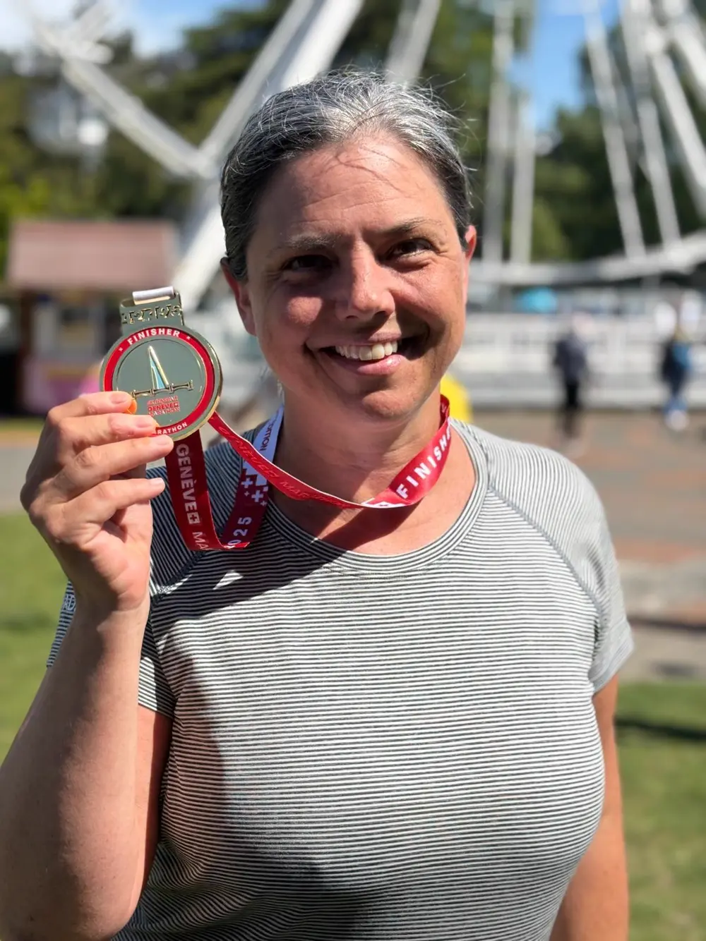 Runner smiling with her marathon finisher medal