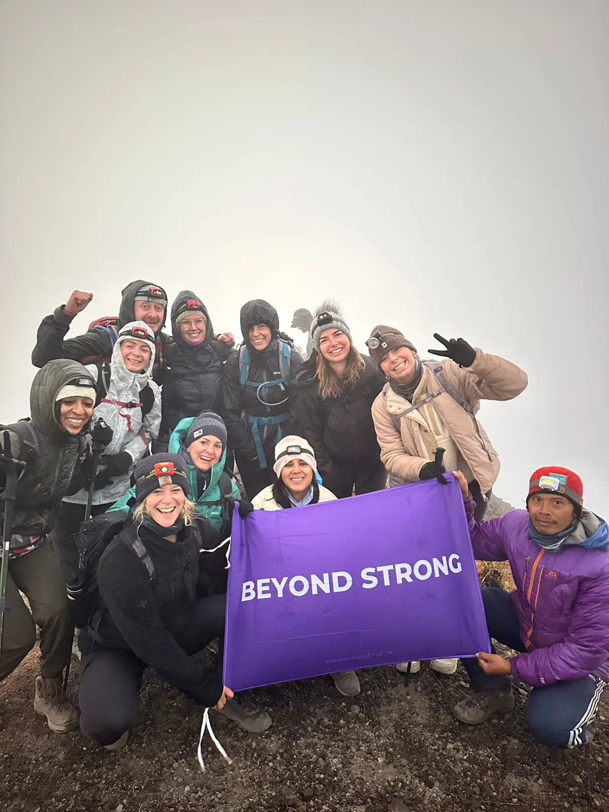 Group at a summit with the Beyond Strong flag