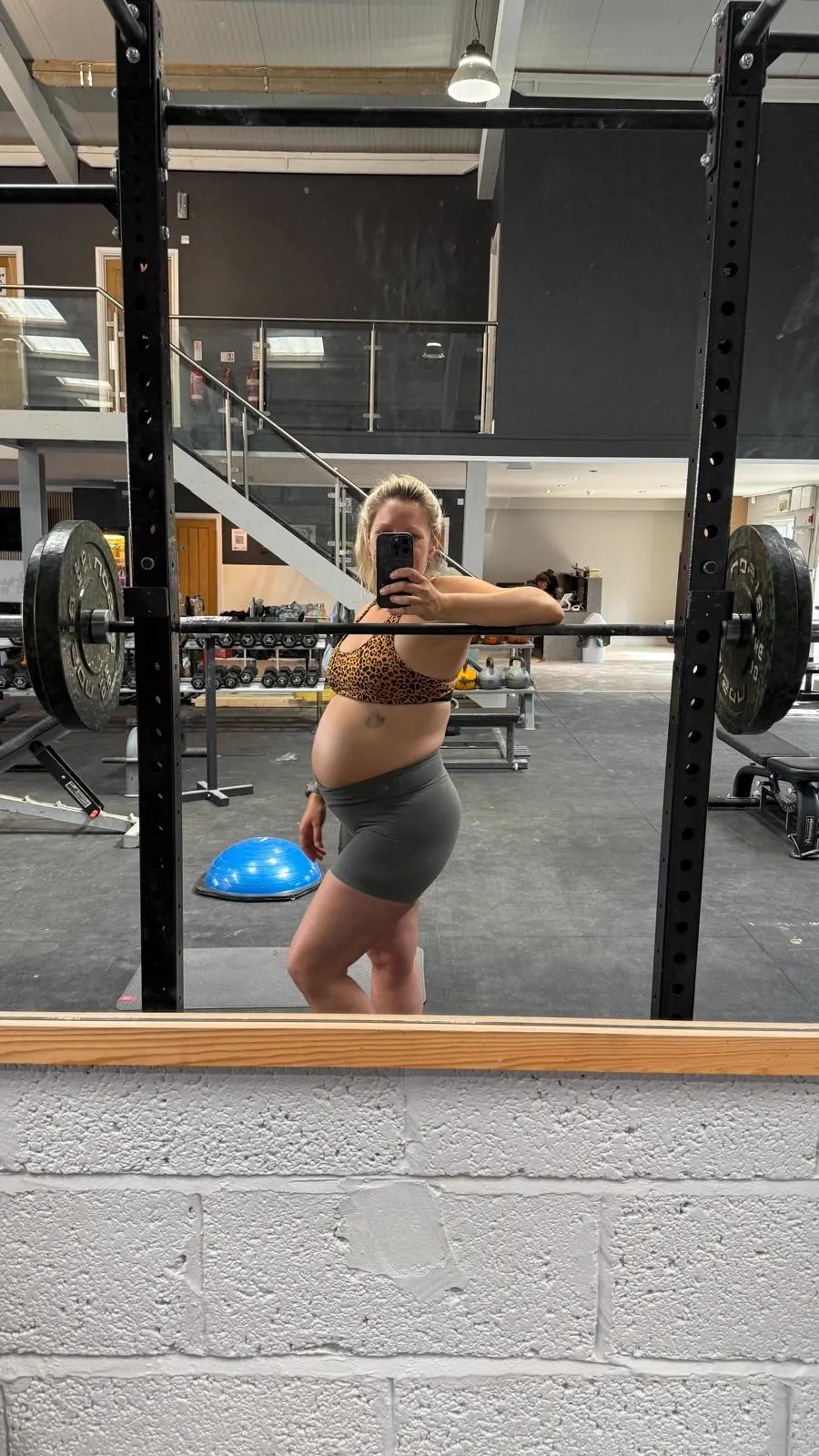 Pregnant client strength training in the gym