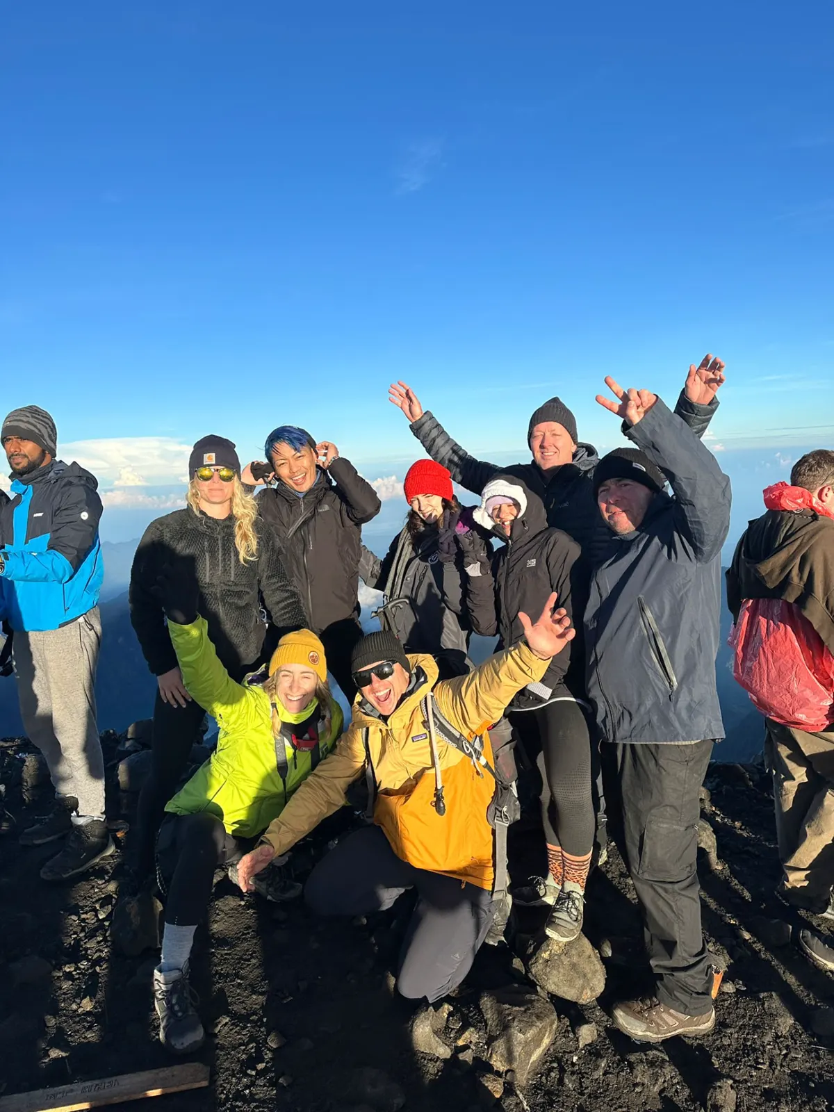 Group at a mountain summit at sunrise