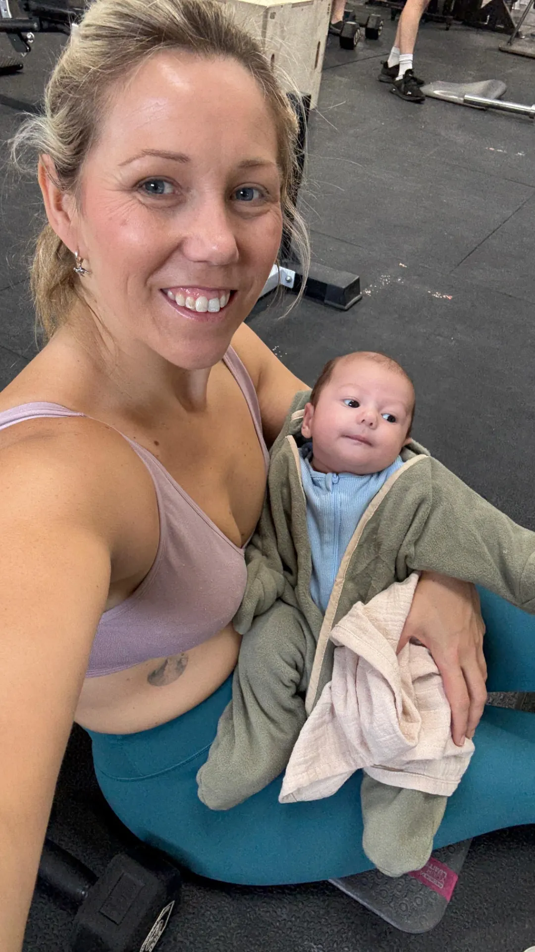 New mum training in the gym with her baby